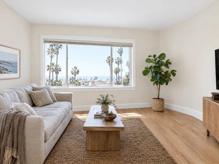 After: The same living room with smooth warm-white walls and crisp ceiling lines